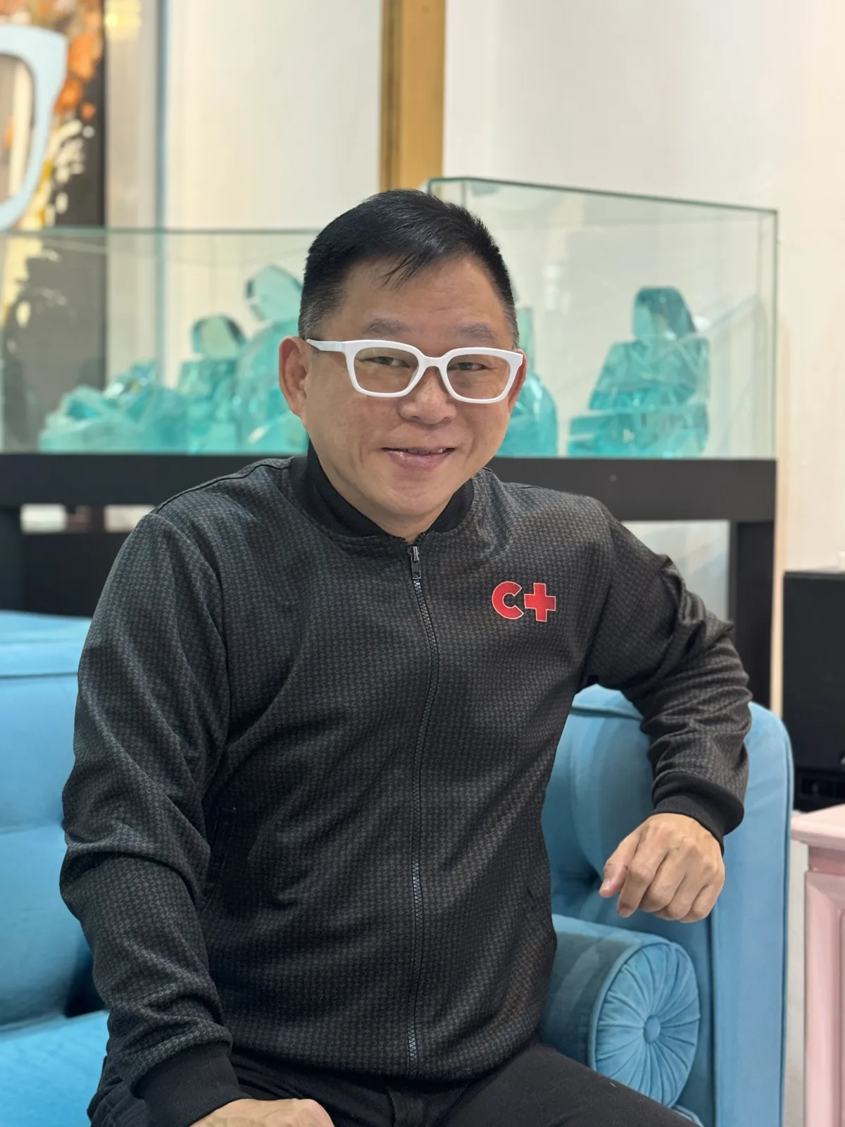 Coach Chinkee Tan seated on a blue sofa